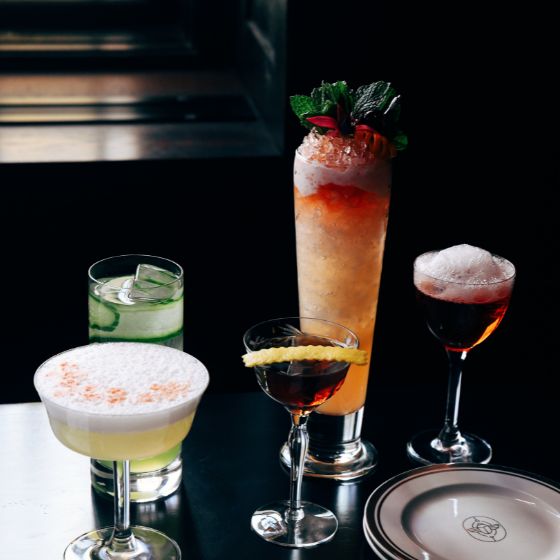 Five cocktails in a variety of glasses