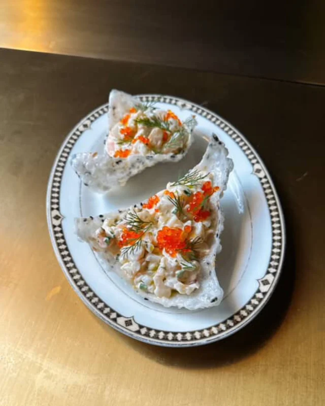 A fresh twist to start your evening right —

Our Rice Cracker Shrimp Salad combines chilled shrimp, trout roe, tzatziki, garlic, sesame, mint oil, and dill on crisp rice crackers for a flavor-packed bite that awakens the senses.

Your next unforgettable meal starts here.